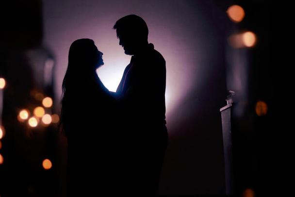 Silhouette Of Romantic Couple. LoveStory and Lights and Bokeh - Photo, image