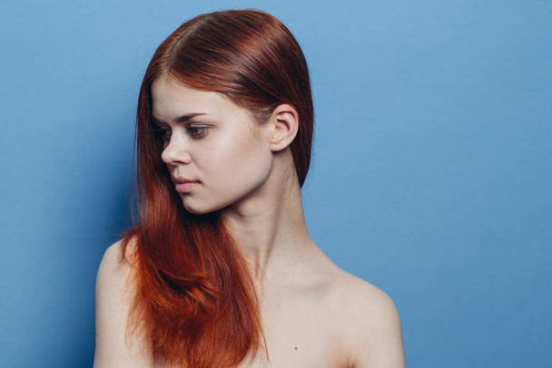 redhead woman naked shoulders hair care blue background - Photo, image