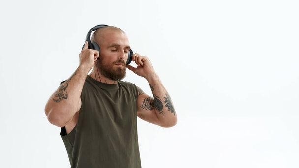 Man enjoying while listening music in earphones - 写真・画像