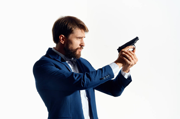 male Agent with a gun in hand isolated background - Foto, afbeelding