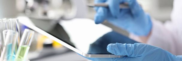 Scientist chemist enters results of research into tablet closeup - Fotografie, Obrázek