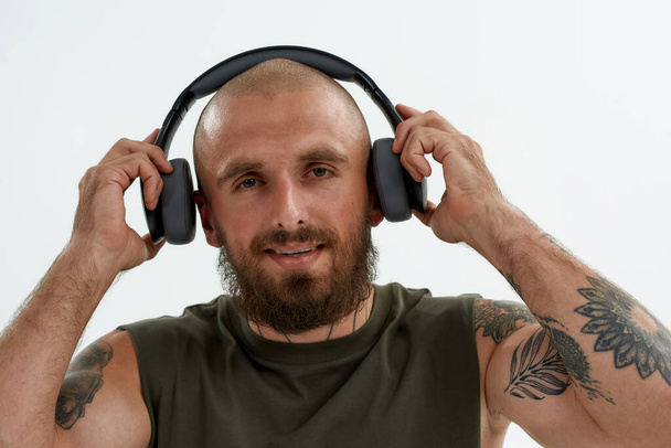 Caucasian man taking off earphones on his ears - Foto, imagen