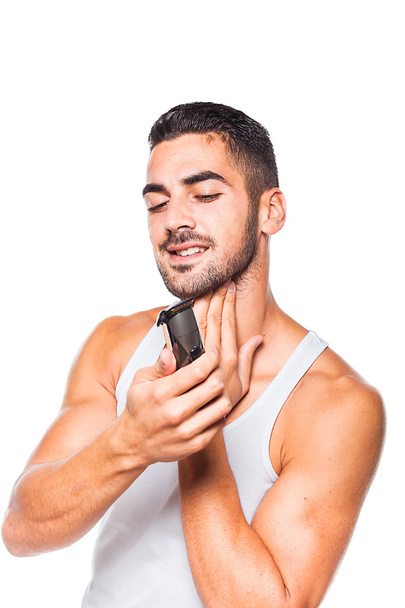 young handsome man trimming his beard - Foto, afbeelding