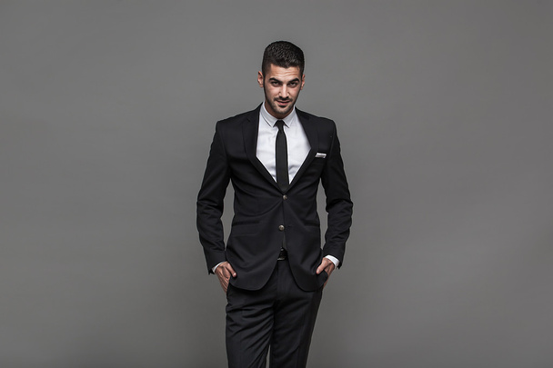 handsome elegant man on grey background - Foto, imagen