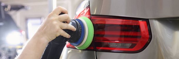 Cleaning rear lights on car from scratches with polishing machine - Photo, Image