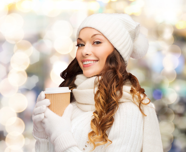 smiling young woman in winter clothes with cup - Foto, immagini