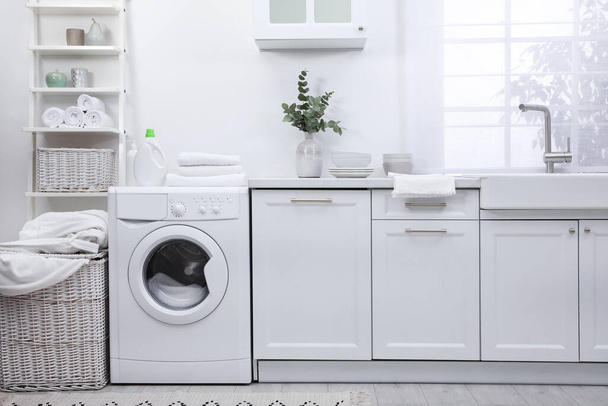 Kitchen interior with washing machine and stylish furniture - Фото, изображение