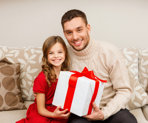smiling father and daughter holding gift box - Fotó, kép