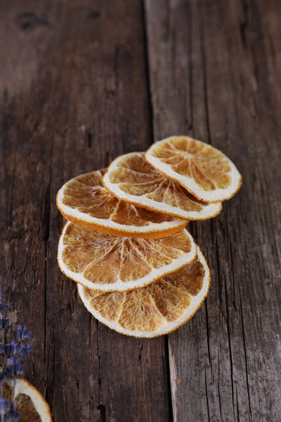 Decor with dried oranges on a wooden background - Photo, Image