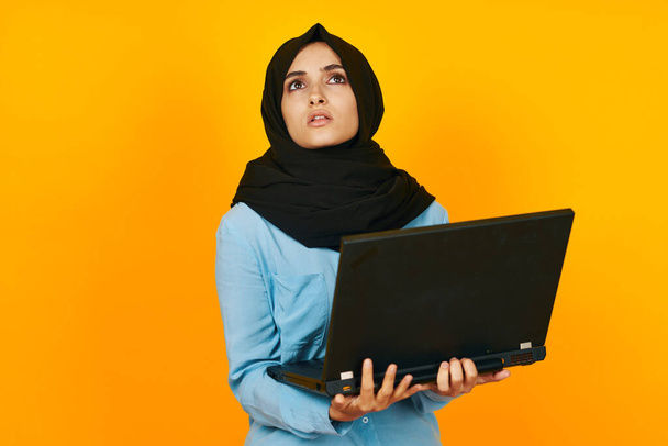 arab woman with laptop in hands technology emotions ethnicity model - Foto, afbeelding