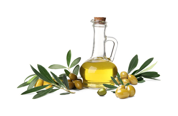 Jug of oil, ripe olives and leaves on white background  - Foto, afbeelding