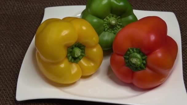 Peppers in three colours on a white plate - Footage, Video