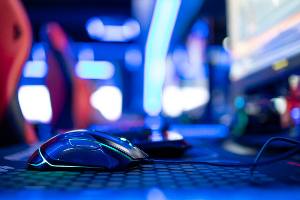 Close up view of computer mouse in video game room. Entertaining industry. - Photo, Image