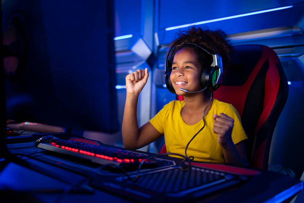 Professional girl gamer plays video games and celebrating victory. - Photo, Image