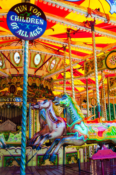 View of Carousel with horses on a carnival Merry Go Round - Photo, Image