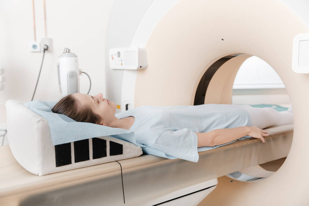 Medical CT or MRI Scan with a patient in the modern hospital laboratory. Interior of radiography department. Technologically advanced equipment in white room. Magnetic resonance diagnostics machine - Foto, Imagen