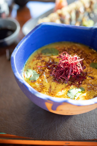 A vertical closeup shot of delicious pumpkin cream soup with some beet in a beautiful bowl - Fotografie, Obrázek