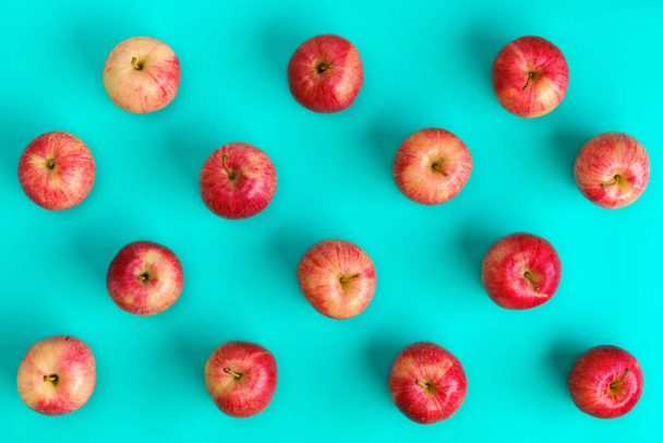 Fruit pattern of red apple on blue background. Flat lay, top view. Pop art design, creative summer concept. Food background. - Fotoğraf, Görsel