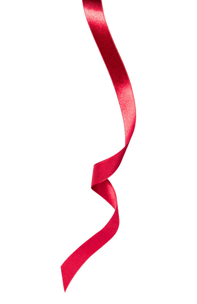 Shiny satin ribbon in red color isolated on white background close up. Ribbon image for decoration design. - Foto, afbeelding