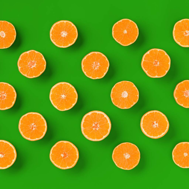 Fruit pattern of fresh orange tangerine or mandarin on green background. Flat lay, top view. Pop art design, creative summer concept. Citrus in minimal style. - Fotoğraf, Görsel