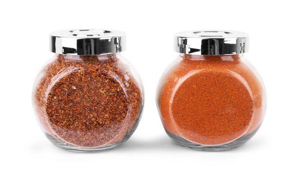 glass jars with various spices flying on white background - Photo, image