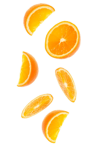 falling fresh orange fruit slices isolated on white background closeup. Flying food concept. Top view. Flat lay. Orange slice in air, without shadow. - Foto, immagini