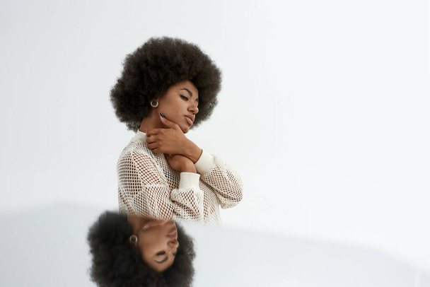 Young thinking black woman with mirror reflection - Fotoğraf, Görsel