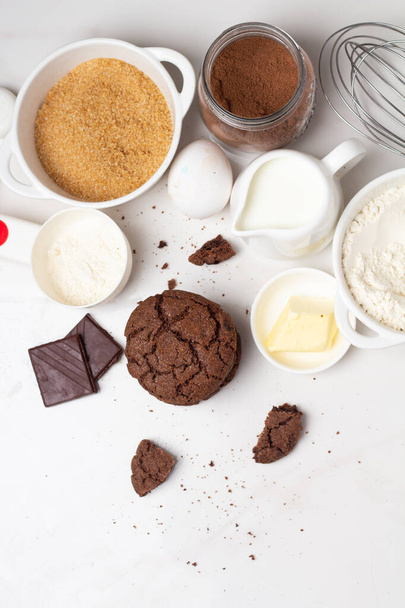 top view of homemade chocolate cookies surrounded by ingredients  - 写真・画像