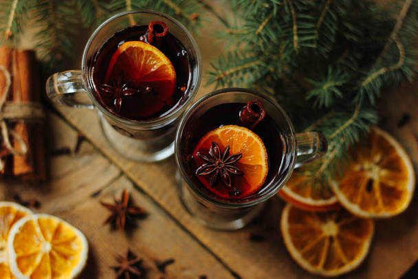 Glasses of red mulled wine on table with cinnamon sticks on wight backround - Photo, image