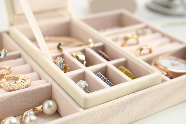 Jewelry box with stylish golden bijouterie on white table, closeup - Fotoğraf, Görsel