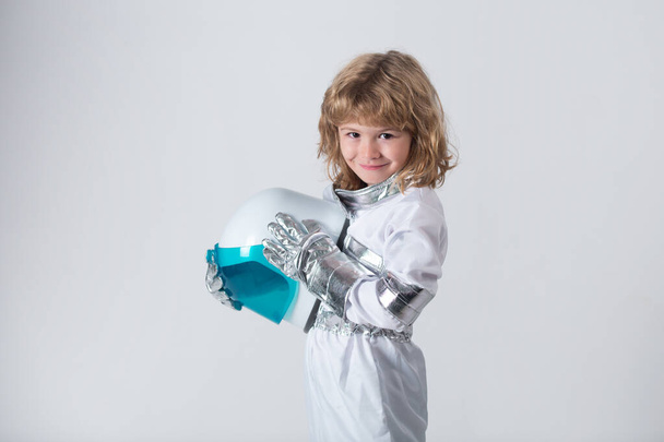 Kid boy exploring space. Portrait of cute kids in space suits holding helmet . Cosmonautics day concept. - Photo, image