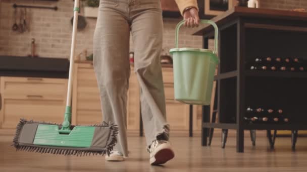 Matala kulma laukaus tunnistamaton nainen casualwear pesulattia moppi modernissa asunnossa - Materiaali, video