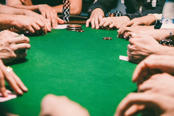 A group of friends playing Texas Hold 'Em during their leisure time - Фото, изображение