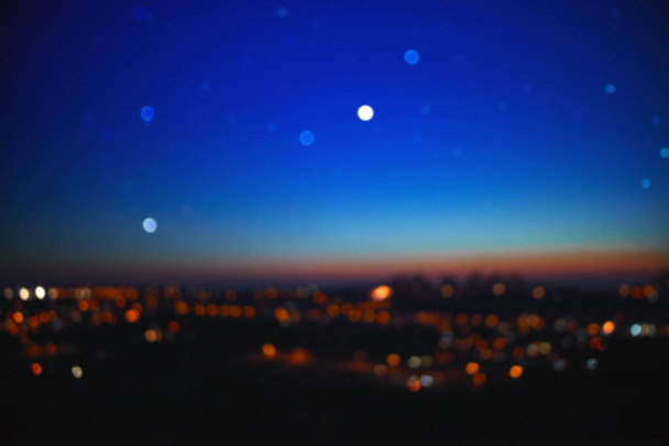 Out of focus landscape with bokeh star and distant city streetlights. - Фото, изображение