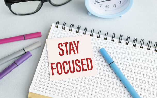 STAY FOCUSED text on notebook and other office equipment such as - Valokuva, kuva