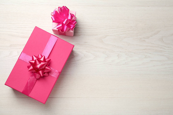 Pink gift boxes on white wooden table, flat lay. Space for text - Valokuva, kuva