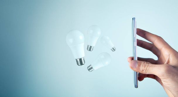 there are light bulbs on the phone - Φωτογραφία, εικόνα