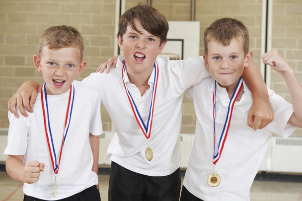 Male School Sports Team In Gym With Medals - Zdjęcie, obraz