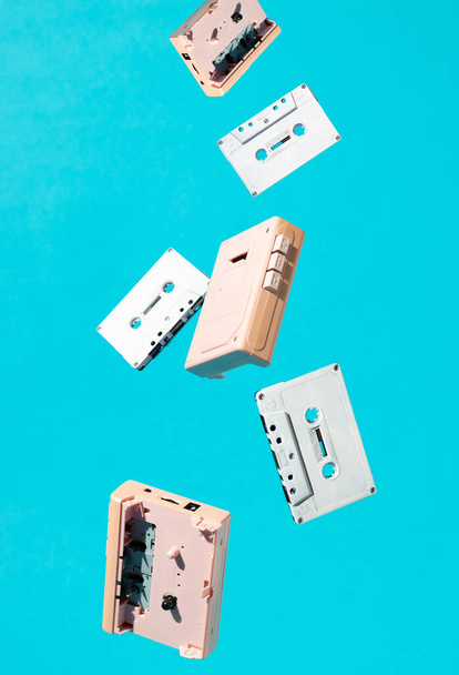 Cassettes and walkmans fall from the sky. Minimal style retro  concept. - Φωτογραφία, εικόνα