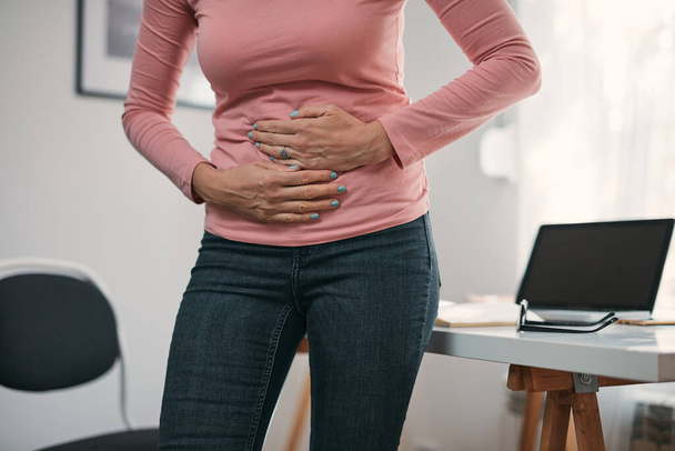 Woman with stomach pain and issues at home. - Foto, Imagen