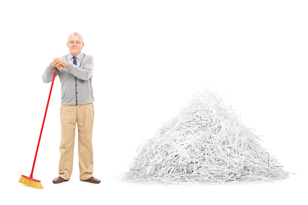 Senior by pile of shredded paper - 写真・画像