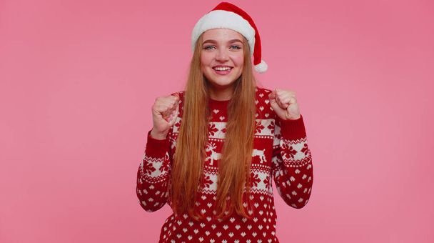 Cheerful girl in red sweater Christmas Santa shouting, celebrating success, winning, goal achievemen - Photo, Image