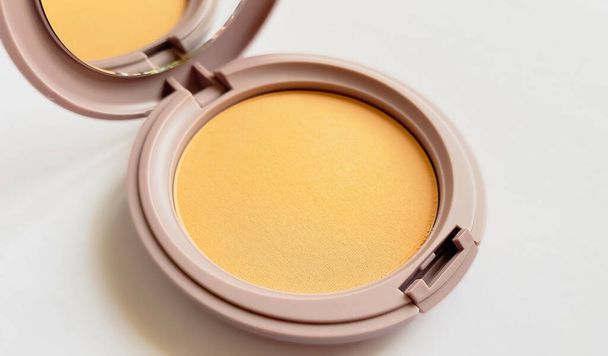 Compact powder for natural color make-up close-up isolated on a white background - Φωτογραφία, εικόνα