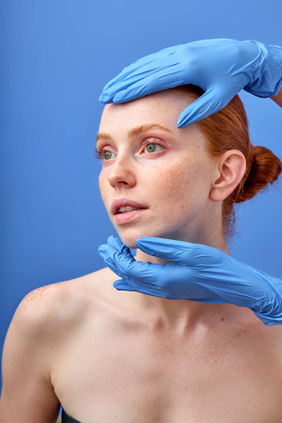 Good-looking woman on cosmetology test. Doctor gloves. Cosmetology clinic treatment. - Фото, зображення