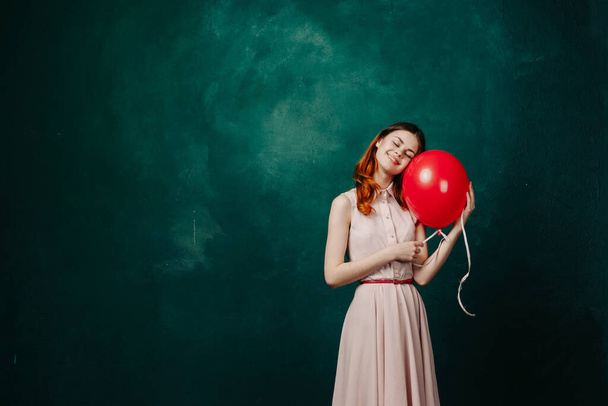 woman with red balloon celebration birthday green background - Фото, изображение
