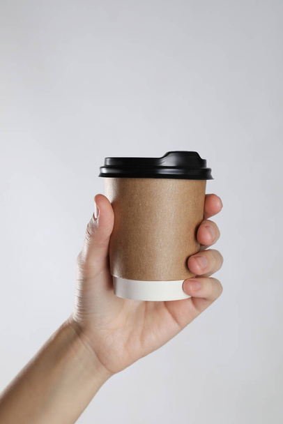 Woman holding takeaway paper coffee cup on white background, closeup - Φωτογραφία, εικόνα