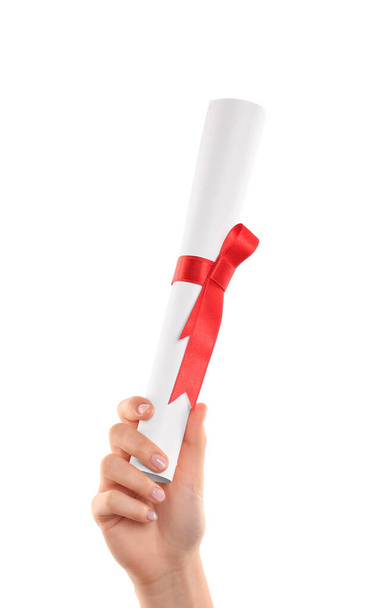 Student holding rolled diploma with red ribbon on white background, closeup - Foto, immagini