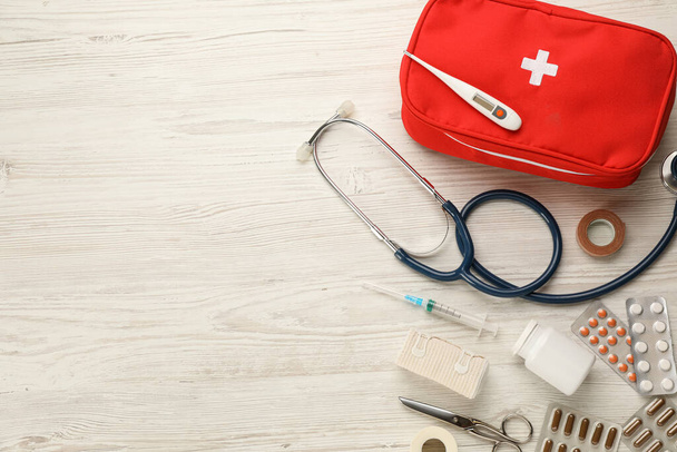 First aid kit on white wooden table, flat lay. Space for text - Fotoğraf, Görsel