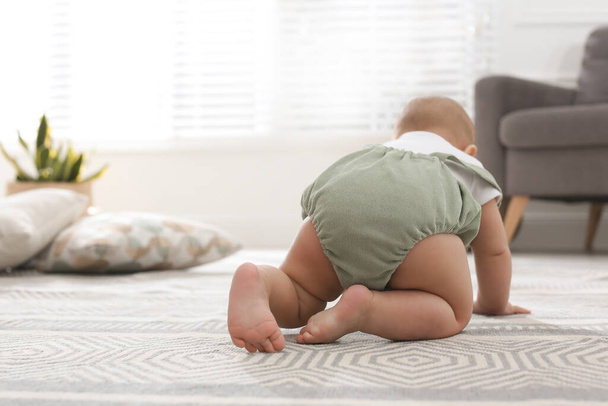 Cute baby crawling at home, focus on legs - Foto, imagen