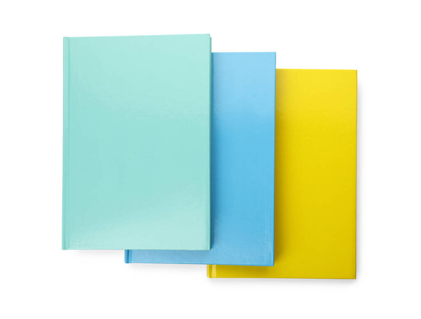 Different colorful hardcover planners on white background, top view - Foto, Imagem